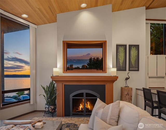 3316 SW 172nd St, Burien, WA 98166 - living room with wooden ceiling, recessed lighting, a warm lit fireplace, and a water view
