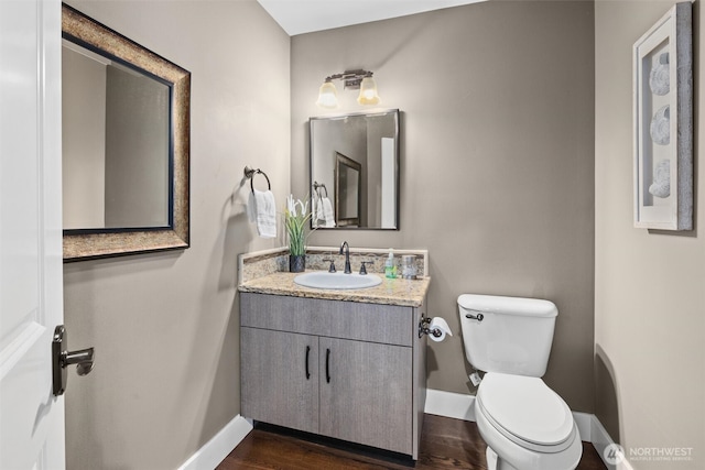 12331 3rd Ave NE, Marysville, WA 98271 - bathroom with baseboards, toilet, vanity, and wood finished floors