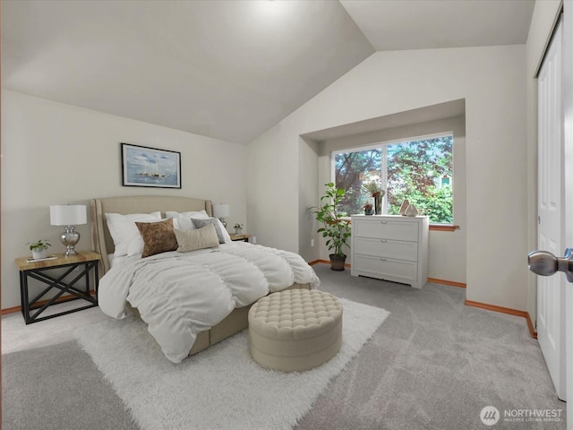 bedroom with carpet floors, vaulted ceiling, and baseboards