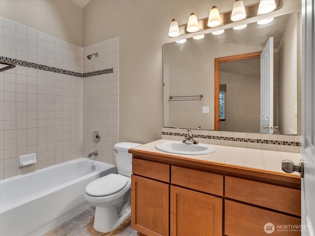 full bath featuring toilet, shower / washtub combination, vanity, and tile patterned floors