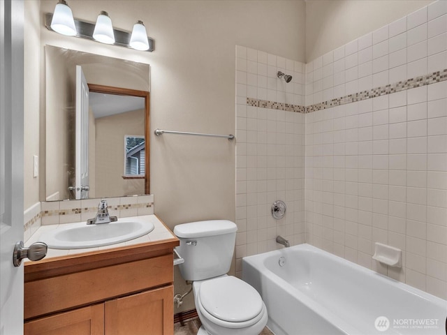 bathroom with toilet, vanity, and shower / washtub combination