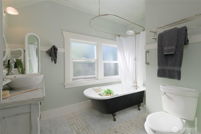 333 N 75th St, Seattle, WA 98103 - full bathroom with a freestanding bath, toilet, vanity, curtained shower, and baseboards