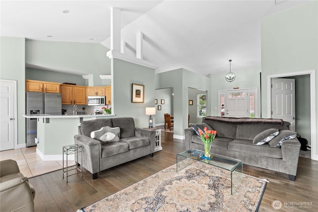 2835 Aspen Shores Dr, East Wenatchee, WA 98802 - living area featuring high vaulted ceiling, light wood finished floors, and baseboards