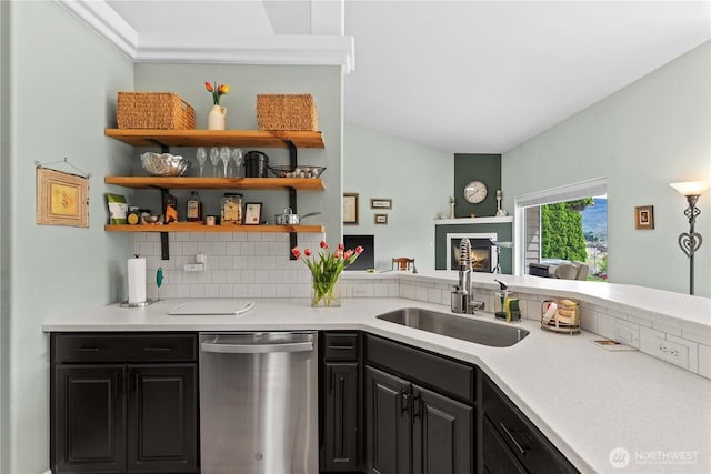 2835 Aspen Shores Dr, East Wenatchee, WA 98802 - kitchen with dishwasher, a sink, decorative backsplash, light countertops, and a glass covered fireplace