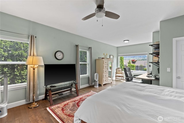 2835 Aspen Shores Dr, East Wenatchee, WA 98802 - bedroom featuring multiple windows, baseboards, a desk, and wood-type flooring