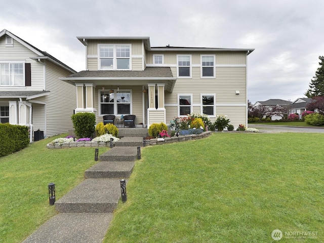 view of front of home featuring a porch, a front lawn, and board and batten siding