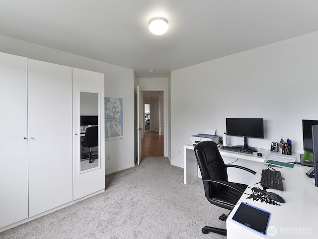 home office featuring light colored carpet and baseboards