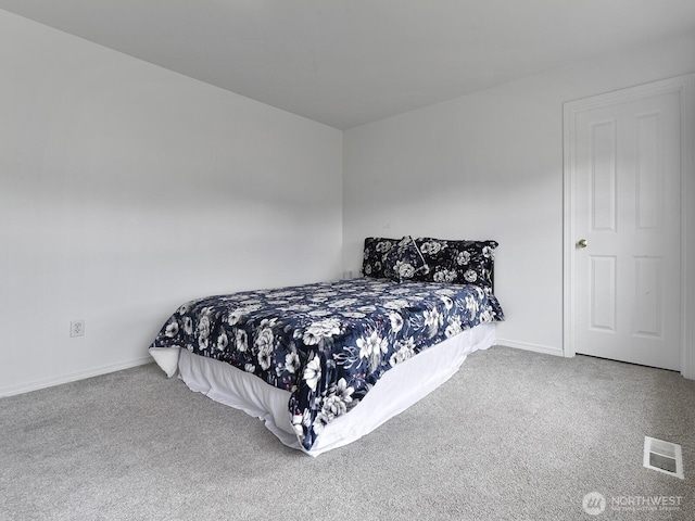 bedroom with carpet floors and baseboards