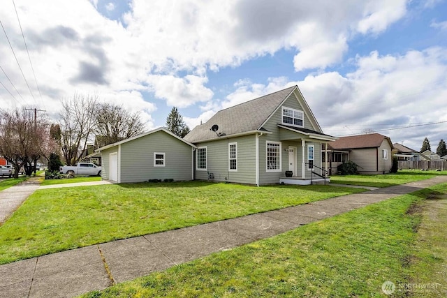 116 E 4th St, Centralia, WA 98531 - view of front of house featuring concrete driveway, a front yard, a garage, and roof with shingles