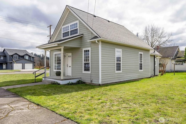 116 E 4th St, Centralia, WA 98531 - view of front of home featuring a front yard and a shingled roof