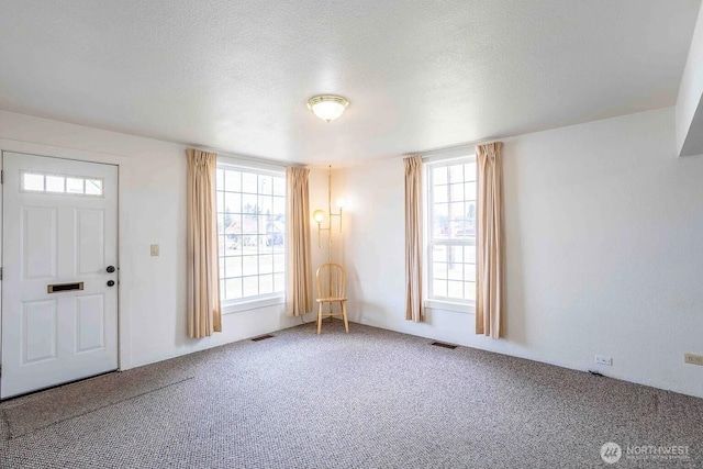 116 E 4th St, Centralia, WA 98531 - carpeted entryway with plenty of natural light and a textured ceiling