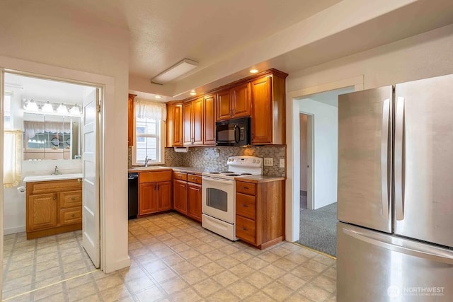 116 E 4th St, Centralia, WA 98531 - kitchen featuring black appliances, a sink, brown cabinets, and light floors