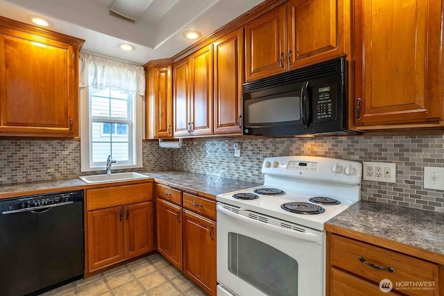 116 E 4th St, Centralia, WA 98531 - kitchen with black appliances, a sink, brown cabinets, and backsplash