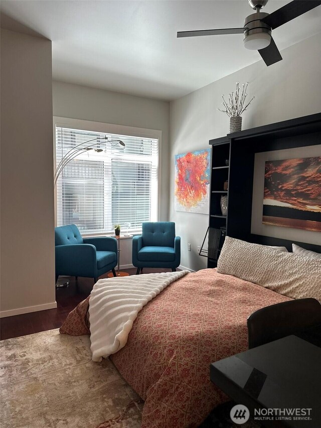2721 1st Ave Unit 103, Seattle, WA 98121 - bedroom with wood finished floors, baseboards, and ceiling fan