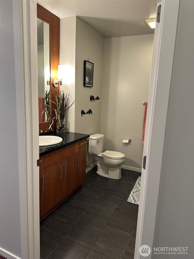 2721 1st Ave Unit 103, Seattle, WA 98121 - bathroom featuring toilet, vanity, and tile patterned floors