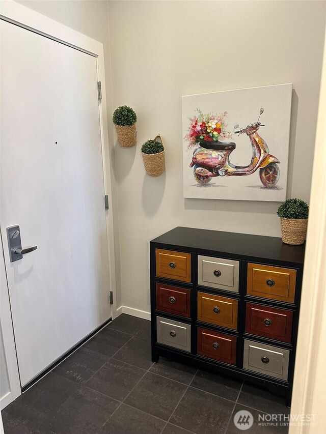 2721 1st Ave Unit 103, Seattle, WA 98121 - foyer entrance with baseboards and dark tile patterned floors