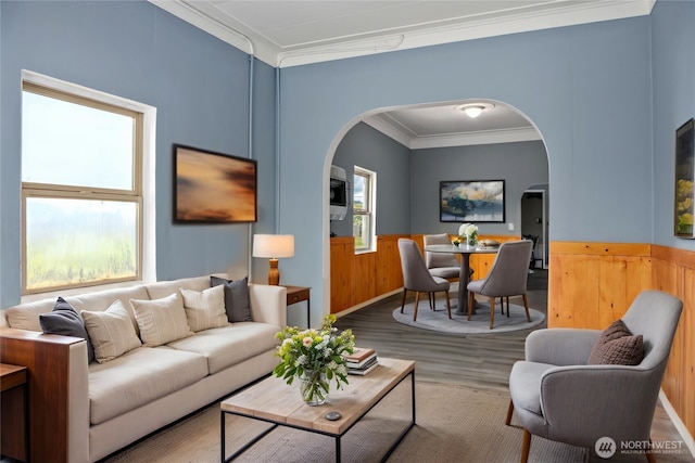 1118 W Wishkah St, Aberdeen, WA 98520 - living room with arched walkways, wood finished floors, ornamental molding, wainscoting, and wood walls