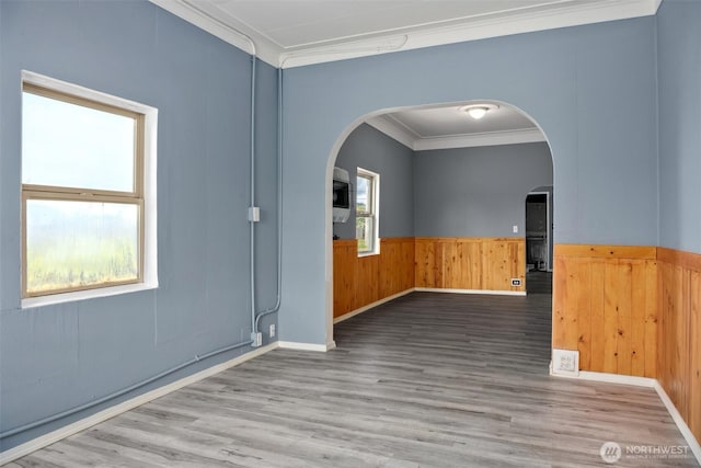 1118 W Wishkah St, Aberdeen, WA 98520 - spare room featuring crown molding, arched walkways, wood finished floors, wainscoting, and wood walls