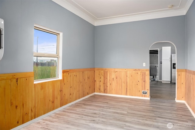 1118 W Wishkah St, Aberdeen, WA 98520 - unfurnished room with a wainscoted wall, wood finished floors, ornamental molding, and arched walkways