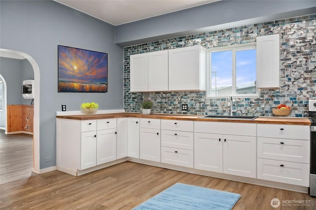 1118 W Wishkah St, Aberdeen, WA 98520 - kitchen featuring butcher block counters, a sink, and light wood-style flooring