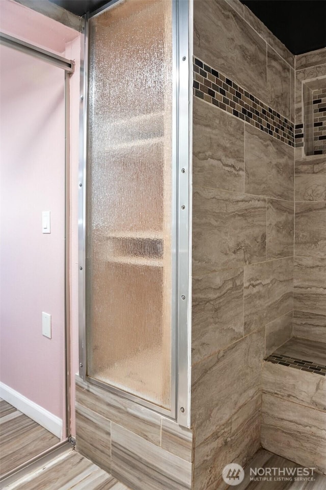 1118 W Wishkah St, Aberdeen, WA 98520 - full bathroom with a stall shower, baseboards, and wood finished floors