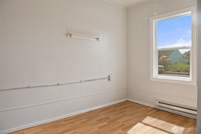 1118 W Wishkah St, Aberdeen, WA 98520 - empty room with baseboard heating, wood finished floors, ornamental molding, and baseboards