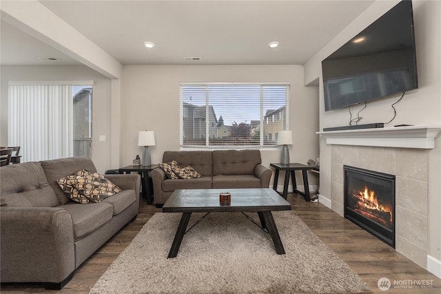 18410 20th Avenue Ct E, Spanaway, WA 98387 - living room with a tile fireplace, wood finished floors, baseboards, and recessed lighting