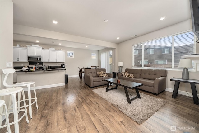 18410 20th Avenue Ct E, Spanaway, WA 98387 - living room featuring dark wood-type flooring, baseboards, and recessed lighting