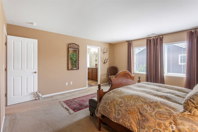carpeted bedroom featuring baseboards and connected bathroom