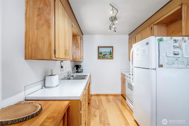 100 Aspen Ln, Packwood, WA 98361 - kitchen featuring white appliances, a sink, light countertops, light wood-style floors, and baseboards