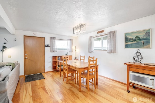 100 Aspen Ln, Packwood, WA 98361 - dining area with light wood-style floors, plenty of natural light, baseboards, and a textured ceiling