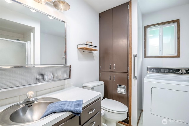 100 Aspen Ln, Packwood, WA 98361 - full bath featuring washer / clothes dryer, vanity, toilet, and a shower with shower door