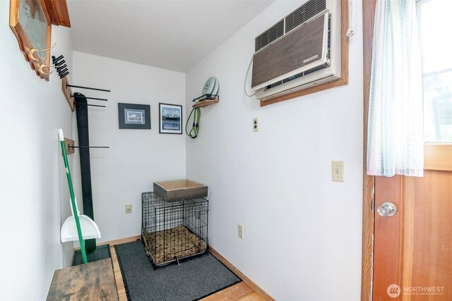 100 Aspen Ln, Packwood, WA 98361 - doorway to outside featuring an AC wall unit, wood finished floors, and baseboards