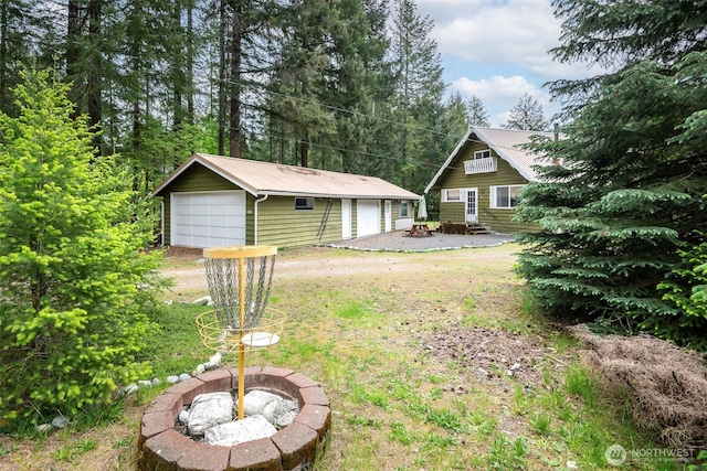 100 Aspen Ln, Packwood, WA 98361 - view of yard with an outdoor fire pit, a garage, an outdoor structure, and entry steps