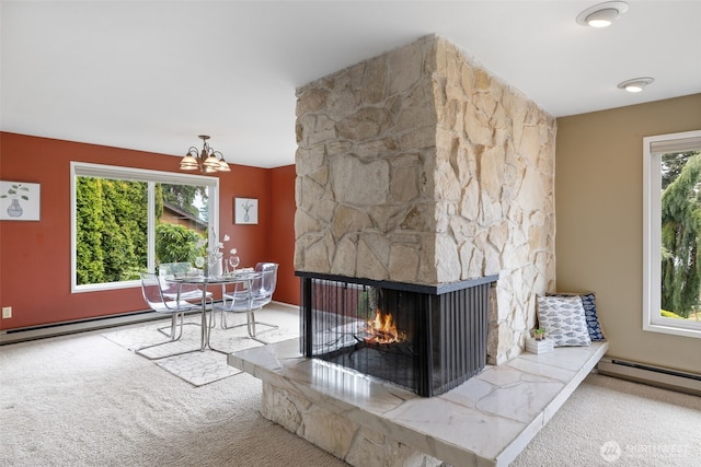 327 Priest Point Dr NW, Tulalip, WA 98271 - carpeted living room with a chandelier, baseboard heating, a baseboard heating unit, and a fireplace