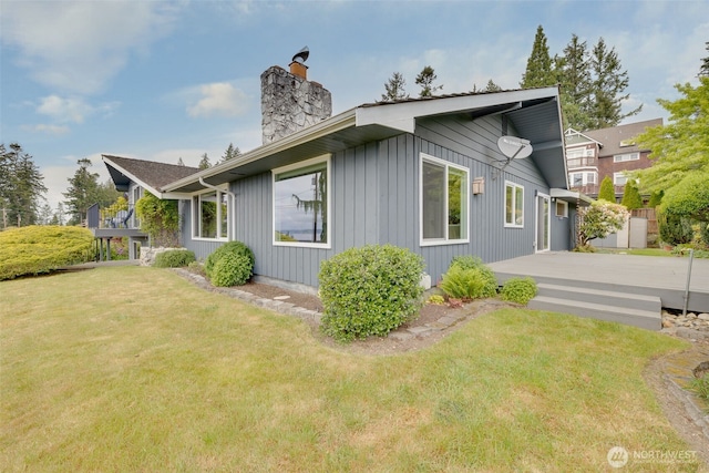 327 Priest Point Dr NW, Tulalip, WA 98271 - view of side of home featuring a chimney and a lawn