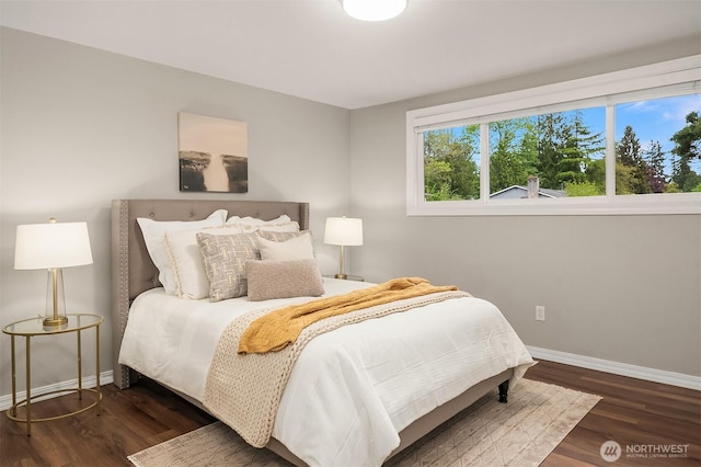 bedroom featuring baseboards and wood finished floors
