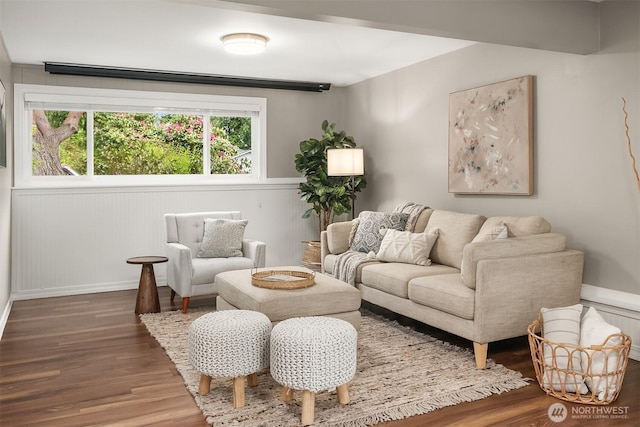 living room with wood finished floors, wainscoting, and baseboards