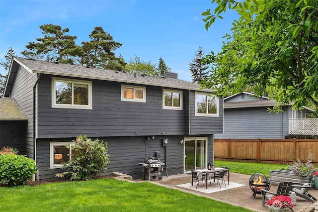 back of house featuring a fire pit, a chimney, a patio, and roof with shingles