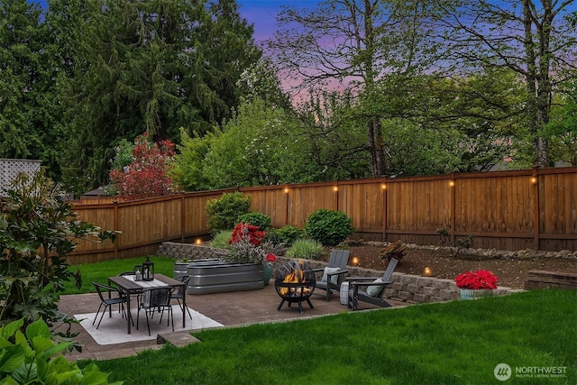 view of yard with an outdoor fire pit and a patio area
