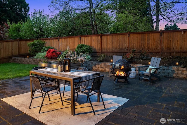 view of patio / terrace featuring a fire pit, a fenced backyard, and outdoor dining space