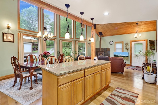 kitchen with a chandelier, light wood finished floors, pendant lighting, french doors, and a kitchen island