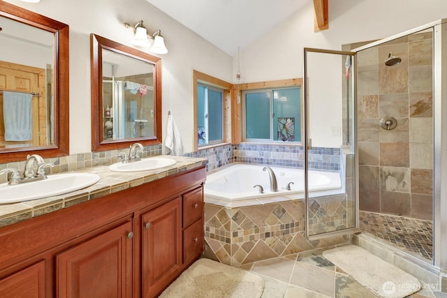 full bath featuring a stall shower, vaulted ceiling, a bath, double vanity, and tile patterned flooring