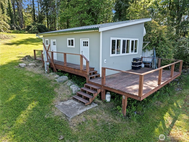 18617 S Vaughn Rd NW, Vaughn, WA 98394 - rear view of house with a lawn, a wooden deck, and metal roof