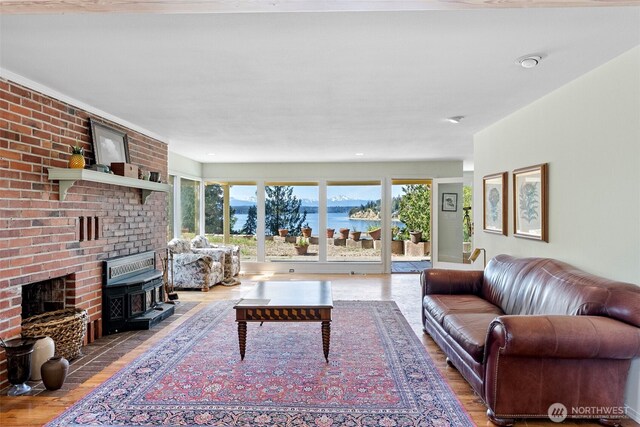 18617 S Vaughn Rd NW, Vaughn, WA 98394 - living room featuring wood finished floors, a water view, and a fireplace
