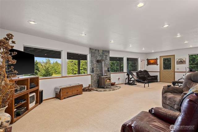 1101 Emerick Rd, Cle Elum, WA 98922 - living area with carpet flooring, a wood stove, recessed lighting, plenty of natural light, and baseboards