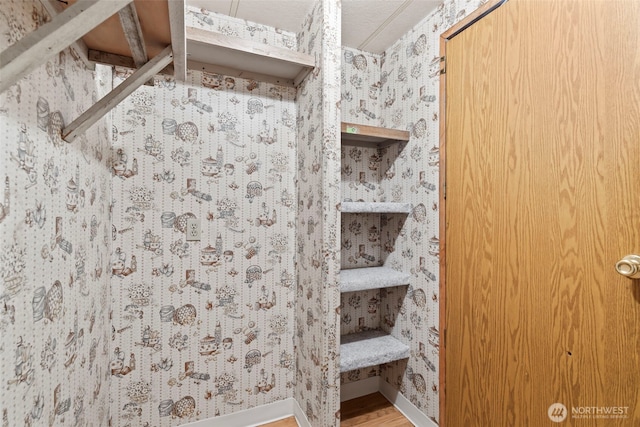 15016 W Thorne Ln SW Unit 7, Lakewood, WA 98498 - bathroom with wood finished floors, wallpapered walls, and baseboards
