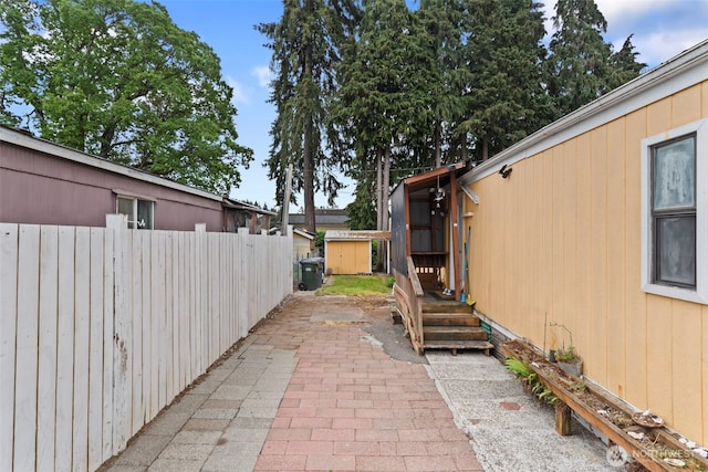 15016 W Thorne Ln SW Unit 7, Lakewood, WA 98498 - view of patio / terrace with fence, a shed, and an outbuilding