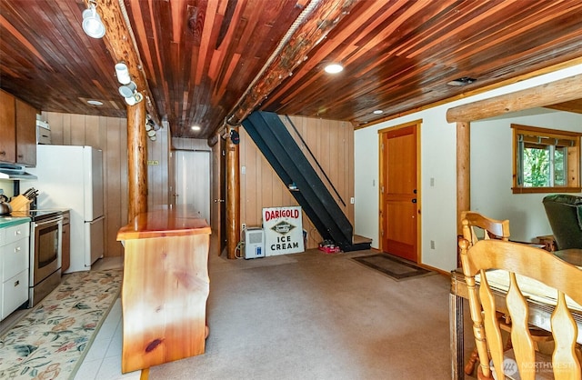 18242 643rd Ave NE Unit 54, 53, Baring, WA 98224 - kitchen featuring electric stove, wood ceiling, wood walls, under cabinet range hood, and freestanding refrigerator