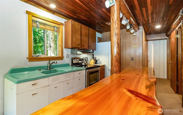 18242 643rd Ave NE Unit 54, 53, Baring, WA 98224 - kitchen featuring butcher block counters, stainless steel electric stove, wood ceiling, a sink, and freestanding refrigerator